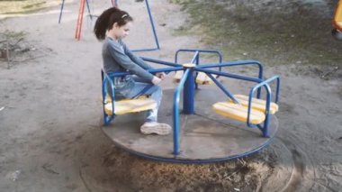 Çocuk parkında sıradan giyinmiş bir kızın portresi.