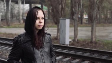 Tren istasyonunda düşünceli bir kadın 
