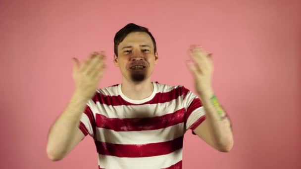 Schöne glückliche junge hübsche Mann posiert isoliert über rosa Wand Hintergrund weht Küsse. — Stockvideo