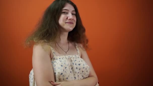 Мечтательная женщина думала о чем-то, на оранжевом фоне — стоковое видео