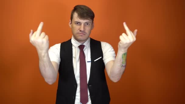 The man shows the middle finger. Middle age handsome man, Showing middle finger, impolite and rude fuck off expression — Wideo stockowe