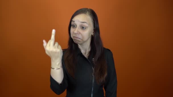 The woman shows the middle finger. Middle age handsome female, Showing middle finger, impolite and rude fuck off expression — Vídeo de Stock