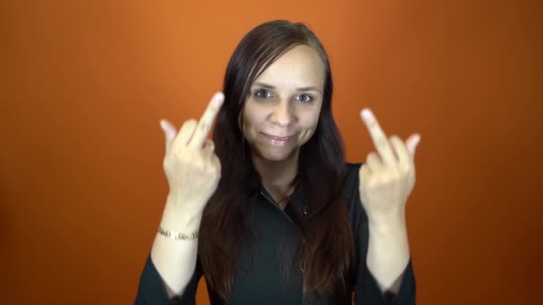 The woman shows the middle finger. Middle age handsome female, Showing middle finger, impolite and rude fuck off expression — Stock Video