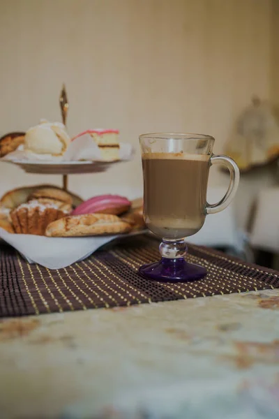 Fotografia de alimentos. Cappuccino quente com diferentes doces caseiros em uma cesta na mesa em café fast food. — Fotografia de Stock