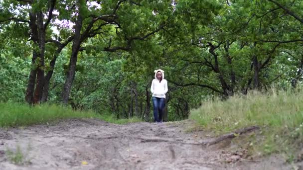 Névtelen nő sétál a parkban. Visszapillantás fiatal nőstényekre séta az ösvényen a csendes őszi parkban — Stock videók