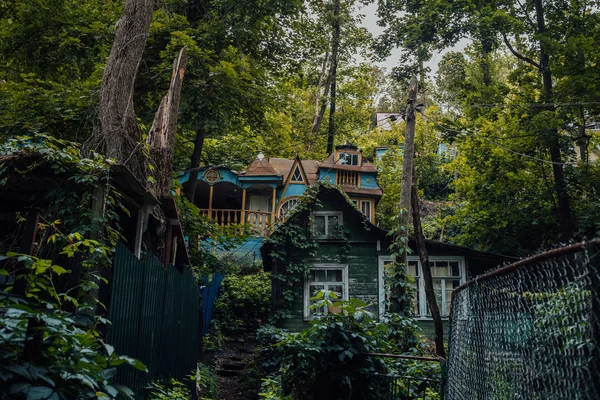 Village house in the forest in cloudy weather. Country house. Residential building in the middle of the forest. House built outside the city. Russian house in the village.