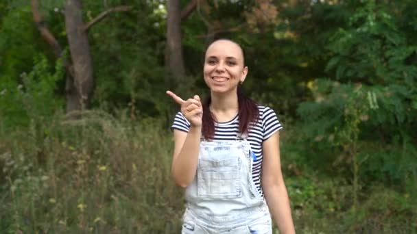 En vacker ung kvinna i vardagskläder ler och visar med pekfingret att man inte ska göra det.. — Stockvideo