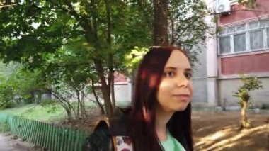  Sırt çantalı genç bir kadın şehirde yürüyor. 