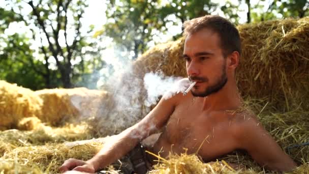 Young Handsome Man Beard Lying Hay Naked Torso Smoking Cigarette — Stock Video