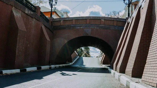 An old stone bridge over the roadway in the city. — Stock Photo, Image