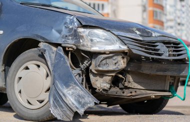 The car after the accident. Broken car on the road. The body of the car is damaged as a result of an accident. High speed head on a car traffic accident. Dents on the car body after a collision on the highway. clipart