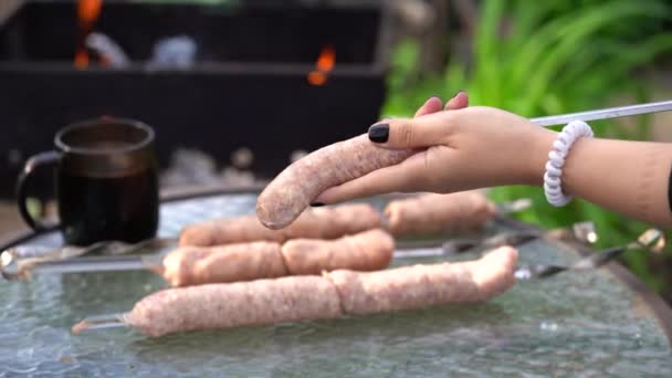 Woman Impales Raw Sausages Skewer Close Woman Hands Hold Skewer — Stock Video