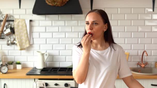 Mujer Joven Comiendo Fresa Parada Cocina Mujer Adulta Disfrutando Bayas — Vídeos de Stock