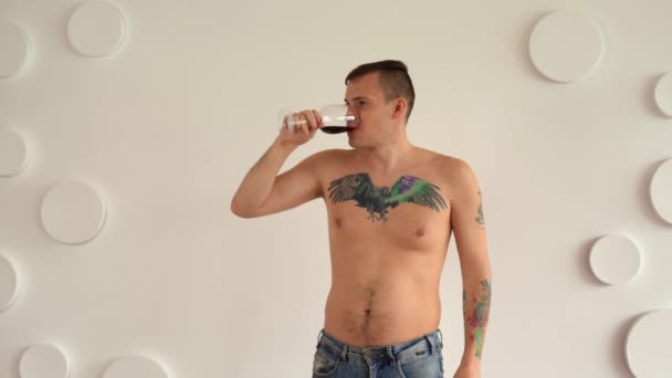 Jovem Com Corpo Tatuagem Peito Bebendo Vinho Tinto Contra Parede — Vídeo de Stock