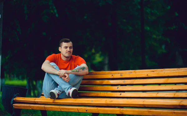 Adult Man Resting Bench Adult Male Red Shirt Jeans Sitting — Stock Photo, Image
