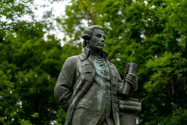 Historical monument in the Park. Statue on a pedestal in a park