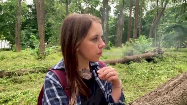 Close up de jovem fumando na floresta. Adulto fumando cigarro feminino no parque florestal . — Vídeo de Stock