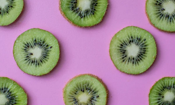 Colorful fruit pattern of fresh kiwi  slices on pastel background. From top view .beautiful kiwi fruit slices background