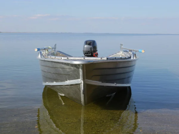 Boat motor on the river in sunny windless weather. One. It\'s deserted. Silence is the peace of solitude.