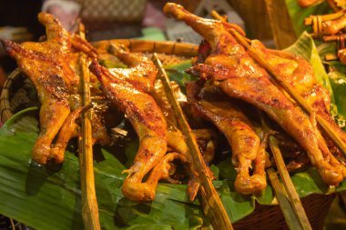 Izgara tavuk, muz üzerinde bambu yaprakları.