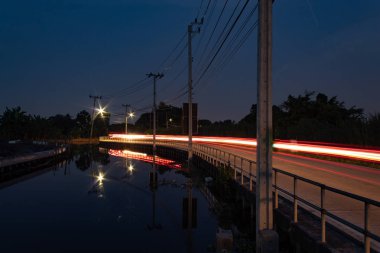 Işığı yansıtan yüzey araba ve yol kenarı.