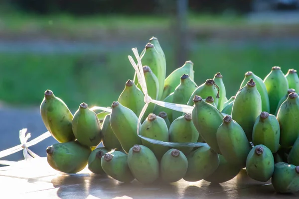 Green bananas will ripen eat placed on the table.