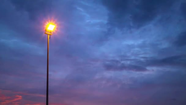 Street Light Illuminates Sunset Light Black Rain Clouds Moving Rapidly — Stock Video