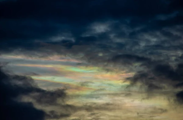 The beauty of the rainbow clouds Above the black clouds in the evening.