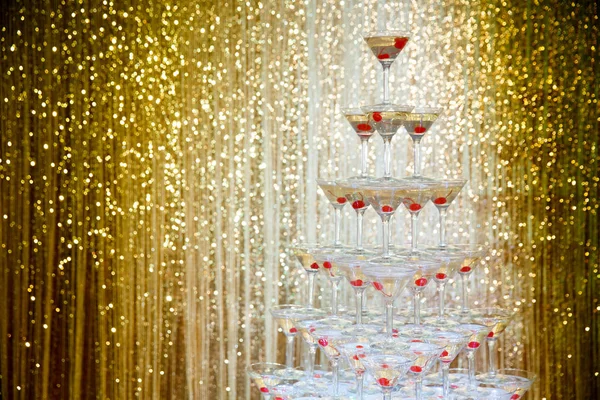 Köpüklü şampanya piramit, gözlük altın duvar önünde partide Kulesi 