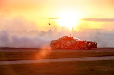 MOSCOW, RUSSIA - MAY 05, 2018: car drifting at motordrome on the sunset, first stage of Russian Drift Series 2018, Moscow Raceway motordrome clipart