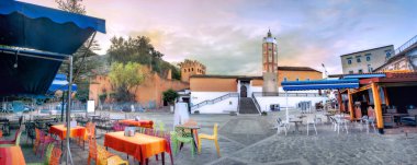 Panoramic cityscape with mosque from street cafe in old medina of blue town Chefchaouen on sunrise. Morocco, North Africa clipart