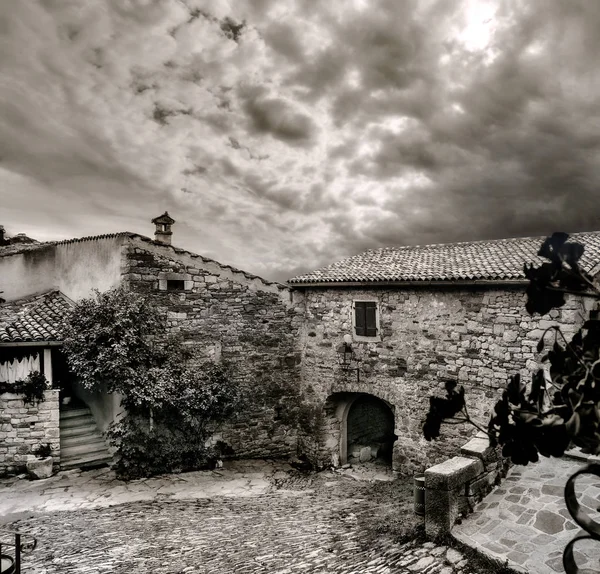 Cityscape of Hum town with small courtyard and old house. Smallest city in the world. Black and white color. Istria, Croatia