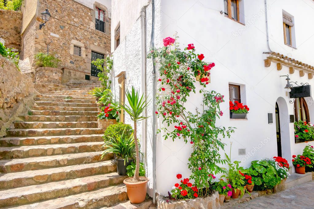 Ancient stone stairs and picturesque facade of house in historic centre Tossa de Mar. Costa Brava, Catalonia, Spain