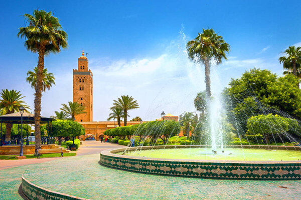 Cityscape with beautiful fountain in park. View of Koutoubia Mos