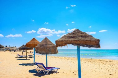 Sunshades on beach at sunny day in Nabeul. Tunisia, North Africa clipart