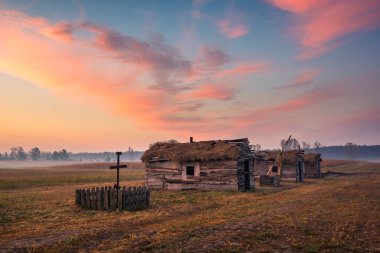 Sunrise over the wooden huts in Lesznowola near Piaseczno, Poland clipart
