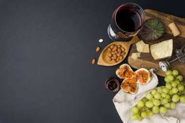 Peynir meze seçimi veya şarap Aperatif küme. Kırmızı şarap, peynir çeşitli, incir siyah arka plan üzerinde ahşap tahta üzerinde.