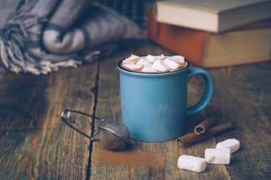 Fincan sıcak kakao ya da sıcak çikolata şekerleme ve tarçın ile ahşap arka plan üzerine yapışır. Kış ruh hali.