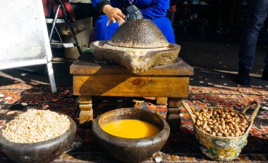 ARGAN OIL. Making of argan oil from argan nuts and seeds in Morocco. Traditional method