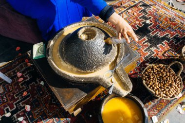 ARGAN OIL. Making of argan oil from argan nuts and seeds in Morocco. Traditional method