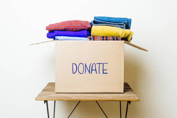 CLOTHES DONATION AND FOOD DONATION CONCEPT. Donation box with clothes and hygiene products.