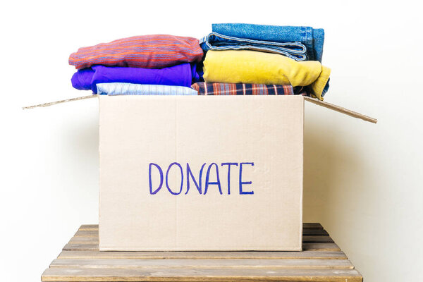 CLOTHES DONATION AND FOOD DONATION CONCEPT. Donation box with clothes and hygiene products.