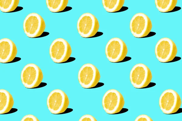 Fresh lemon (lemons) pattern on blue background. Minimal concept. Summer minimal concept. Flat lay