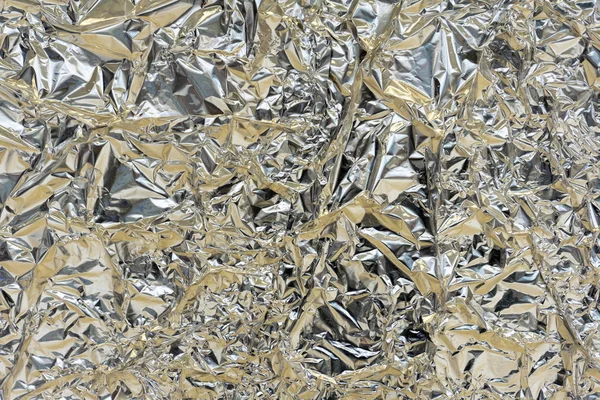 Holographic texture wrinkled metal foil. Hologram abstract 80s s