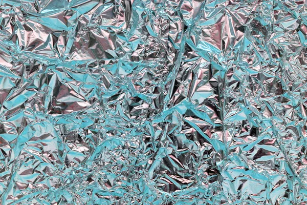 Holographic texture wrinkled metal foil. Hologram abstract 80s s