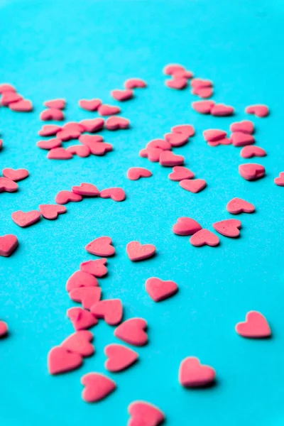 Love concept minimal. Sweet sugar hearts on a colored background
