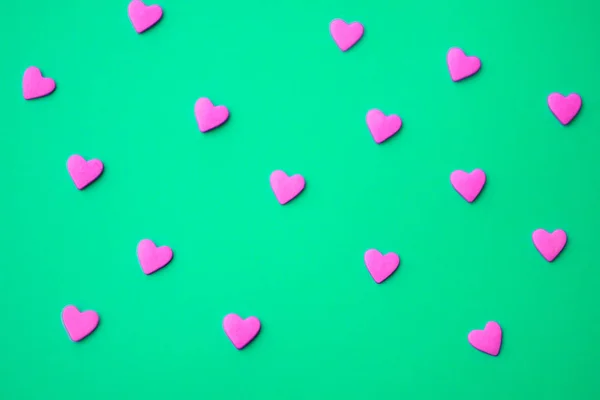 Love concept minimal. Sweet sugar hearts on a colored background