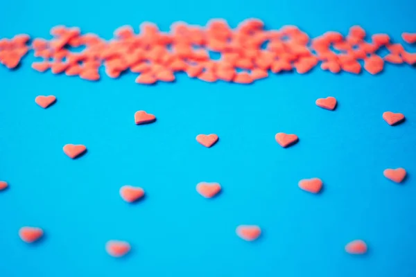 Love concept minimal. Sweet sugar hearts on a colored background