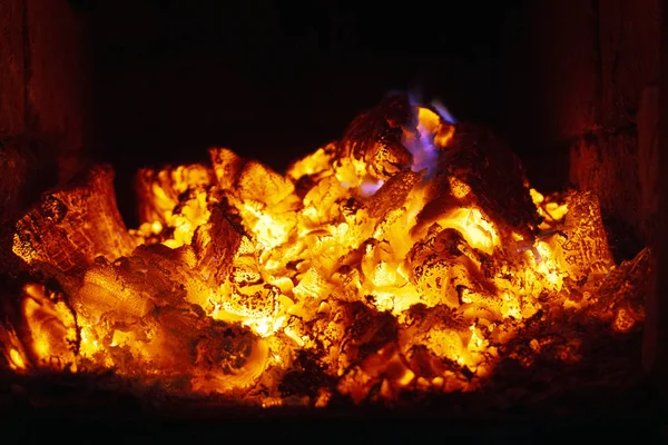 The fire in the furnace. Ember and fire close up. Coals, flames,