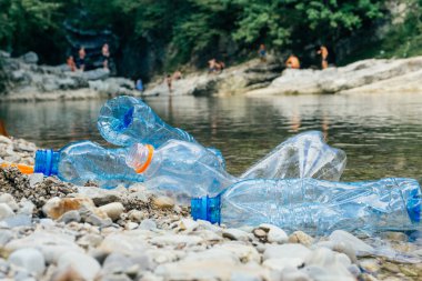 Nehirde Plastik Kirliliği. Kirli plastik şişe ve çanta o